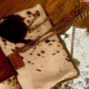 Hide bag with metal shoulder strap